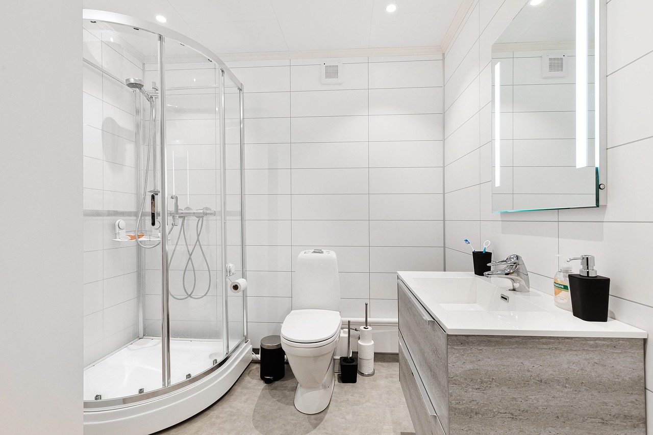 Bright remodeled bathroom with a walk-in shower and wood vanity